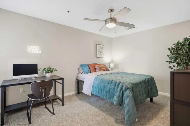 Bed desk chair and neon sign bedroom at Altitude Baton Rouge | Apartment Complex in Baton Rouge Student Accommodation