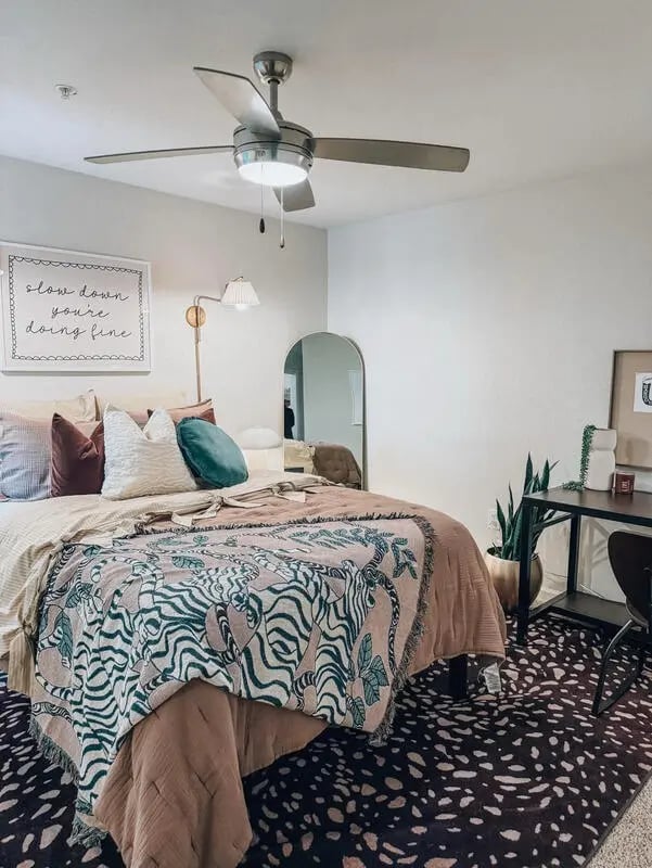 Bed with zebra blanket desk and ceiling fan bedroom at Altitude Baton Rouge | Apartment Complex in Baton Rouge Student Accommodation