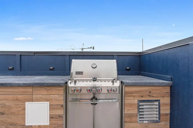 Grill built-in outdoor counter space playing area at The Dean Campustown in Champaign Student Accommodation
