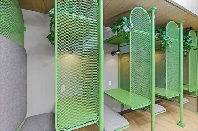 Green pods with desks and seating study area at The Dean Campustown in Champaign Student Accommodation