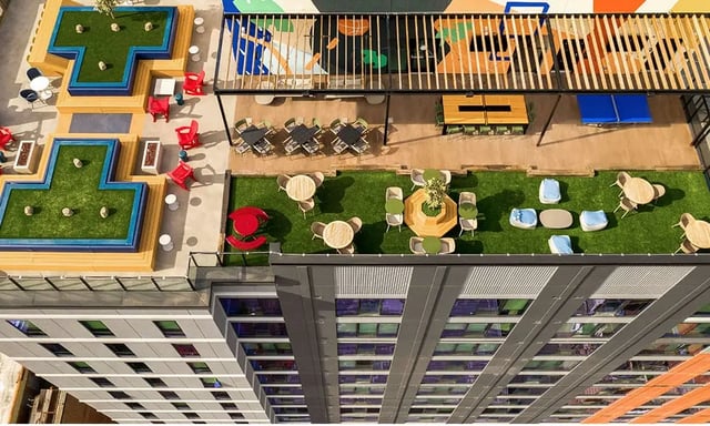 Rooftop seating areas with grass and tables exterior at The Dean Campustown in Champaign Student Accommodation