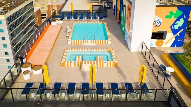 Rooftop pools lounge chairs and murals exterior at The Dean Campustown in Champaign Student Accommodation