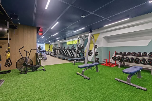 Treadmills weights benches and air bike gym at The Dean Campustown in Champaign Student Accommodation