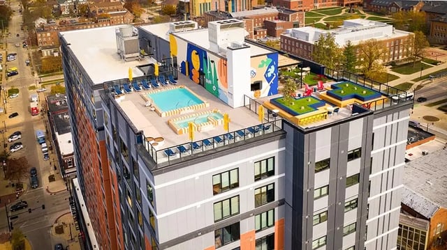 Rooftop pool hot tubs lounge chairs green space amenity area exterior at The Dean Campustown in Champaign Student Accommodation