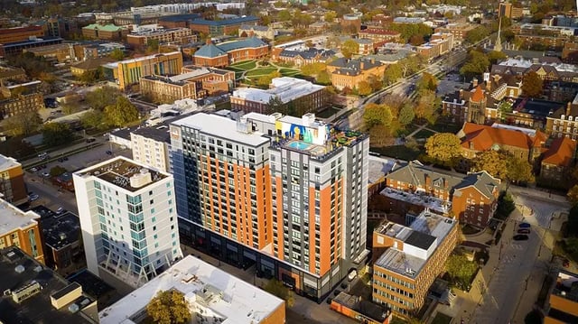 High rise buildings with rooftop pool exterior at The Dean Campustown in Champaign Student Accommodation