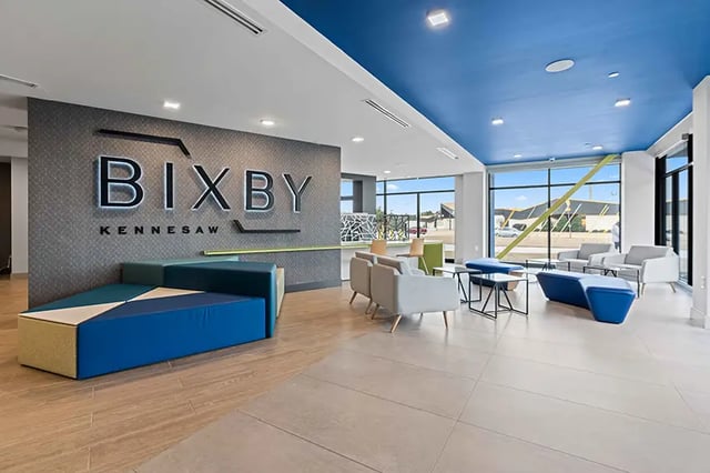 Modern lobby with geometric seating and BIXBY logo Living room at Bixby Kennesaw in Kennesaw Student Accommodation