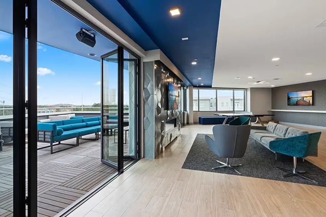 Modern lounge with sofas ping pong table and balcony living area at Bixby Kennesaw in Kennesaw Student Accommodation