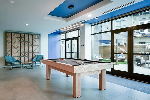 Pool table chairs and outdoor patio area. at Bixby Kennesaw in Kennesaw Student Accommodation