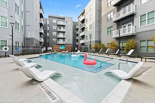 Pool with lounge chairs and inflatable toys exterior at Bixby Kennesaw in Kennesaw Student Accommodation