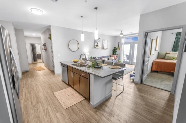 Island kitchen with living room and bedroom visible at Bixby Kennesaw in Kennesaw Student Accommodation