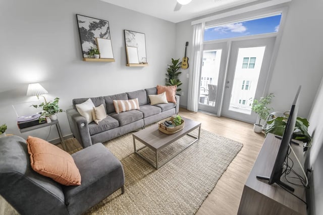 Grey sectional sofa coffee table and TV living room at Bixby Kennesaw in Kennesaw Student Accommodation