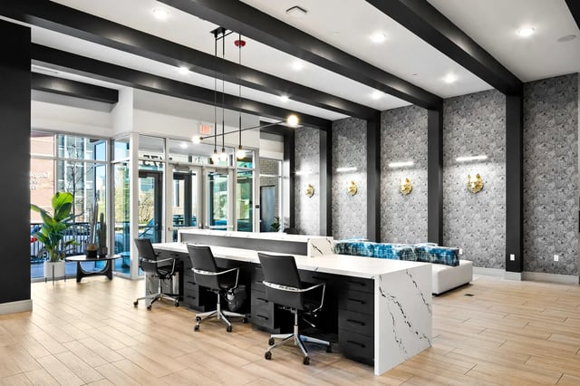 Workstations with chairs and couch lounge area at The Dean Reno in Reno Student Accommodation