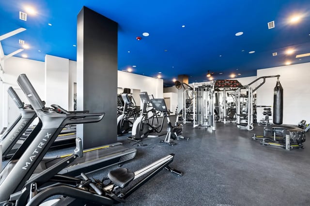 Gym with treadmills ellipticals weight machines and punching bag gym at The Dean Reno in Reno Student Accommodation