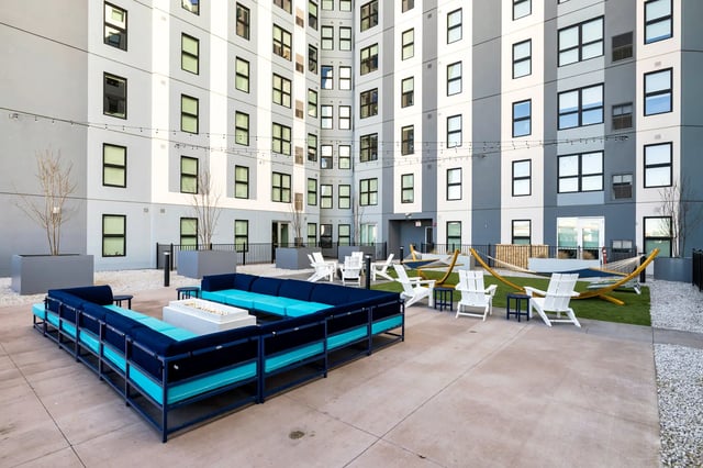 Outdoor seating with couches fire pit hammocks courtyard at The Dean Reno in Reno Student Accommodation