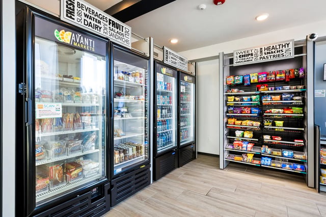 Refrigerated display cases and snack shelves convenience area at The Dean Reno in Reno Student Accommodation