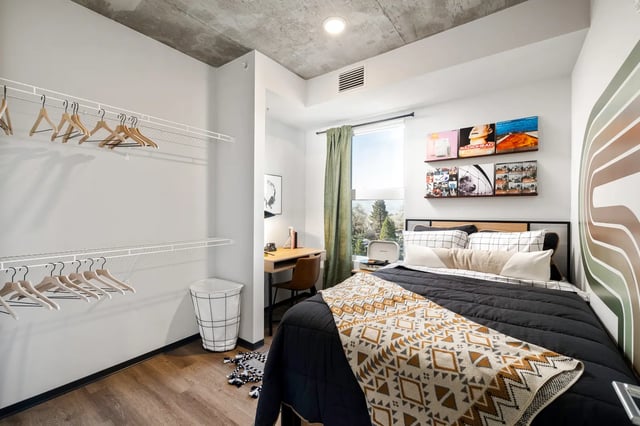 Bed desk closet and vinyl records bedroom at The Dean Reno in Reno Student Accommodation