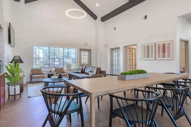 Dining table with chairs and couch common area at Crossing Place in College Station Student Accommodation