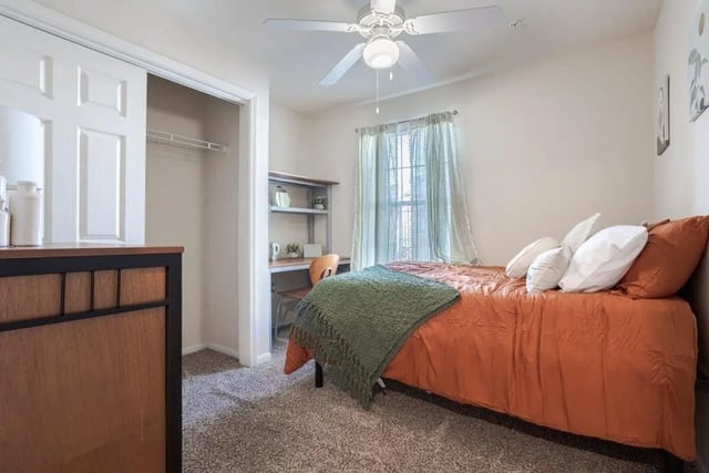 Bed desk closet and ceiling fan bedroom at Crossing Place in College Station Student Accommodation