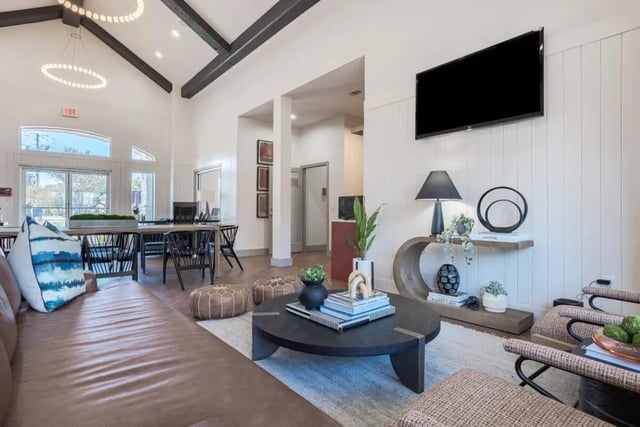 Leather couch coffee table study tables and chairs lounge at Crossing Place in College Station Student Accommodation
