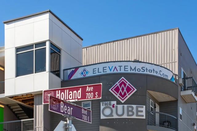 Building exterior with signs and windows Exterior at The Q'ube in Springfield Student Accommodation