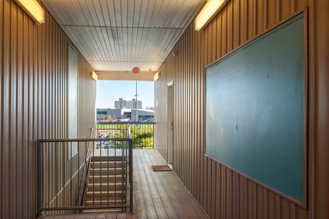 Hallway with stairs metal railing chalkboard exterior at The Q'ube in Springfield Student Accommodation