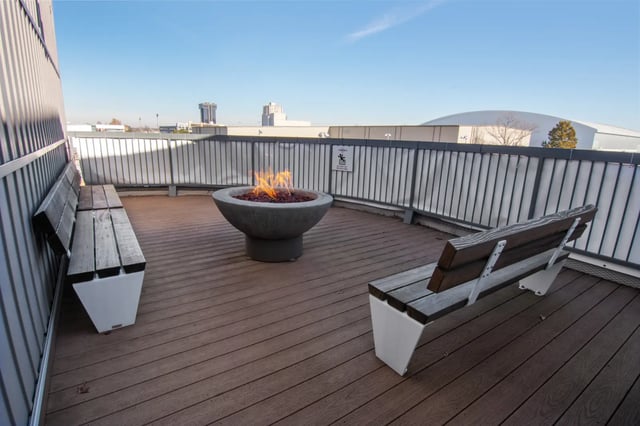 Benches and fire pit on wooden deck outdoor area at The Q'ube in Springfield Student Accommodation