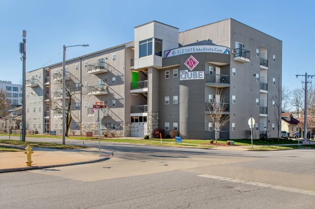Modern apartment building with balconies and signage exterior at The Q'ube in Springfield Student Accommodation