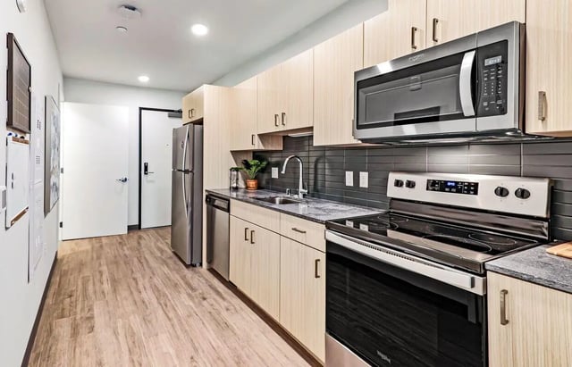 Modern kitchen with stainless steel appliances and cabinets kitchen at Theory U District in Seattle Student Accommodation