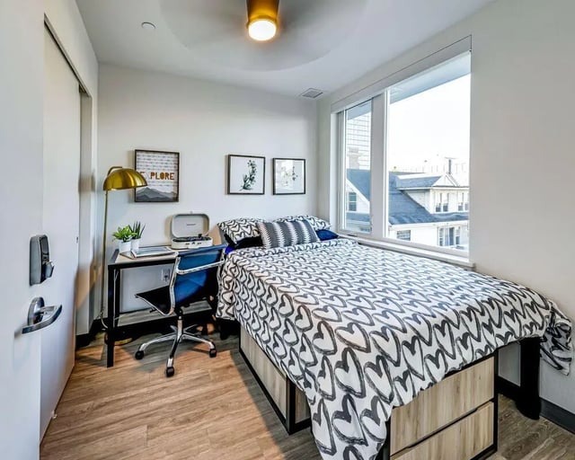 Bed desk lamp record player chair bedroom at Theory U District in Seattle Student Accommodation