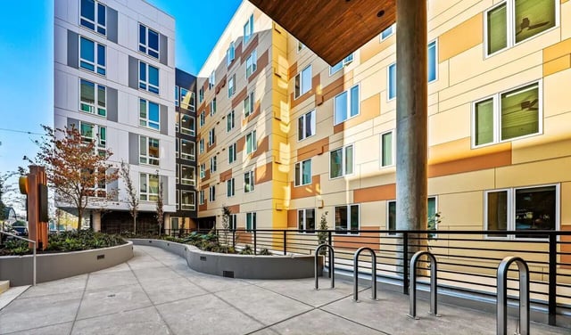 Modern buildings with many windows and bike racks Exterior at Theory U District in Seattle Student Accommodation