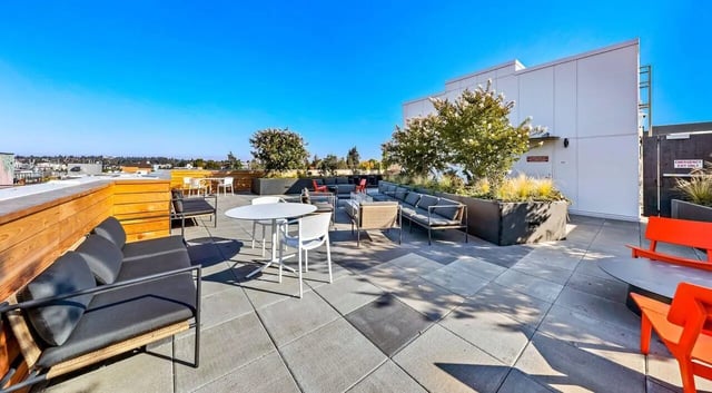 Outdoor seating area with sofas tables and chairs exterior at Theory U District in Seattle Student Accommodation