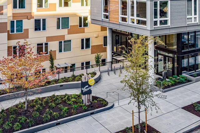 Modern apartment building entrance with landscaped exterior exterior at Theory U District in Seattle Student Accommodation