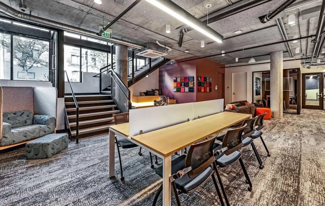 Study area with desk chairs and staircase living room at Theory U District in Seattle Student Accommodation