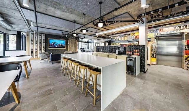 Bar seating kitchen island coffee maker elevator community area at Theory U District in Seattle Student Accommodation
