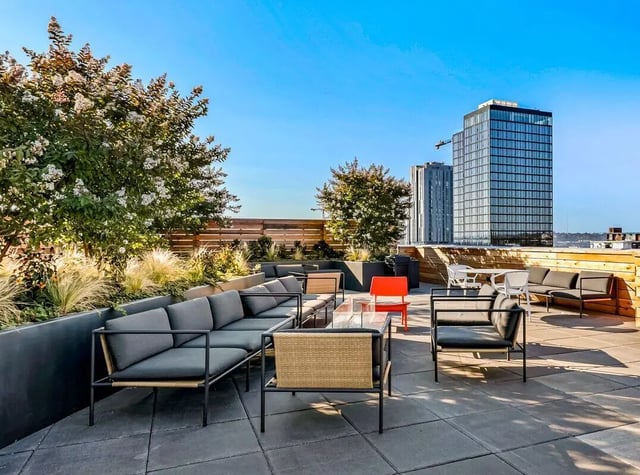 Rooftop patio with lounge seating and tables exterior at Theory U District in Seattle Student Accommodation