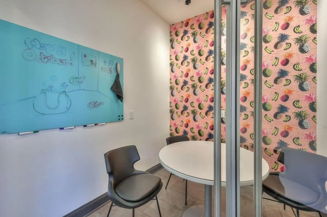 Whiteboard chairs table with fruit wallpaper study area at Cobalt Row in Murfreesboro Student Accommodation