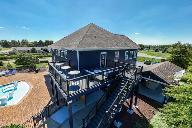 Blue building deck with tables and pool exterior at Cobalt Row in Murfreesboro Student Accommodation