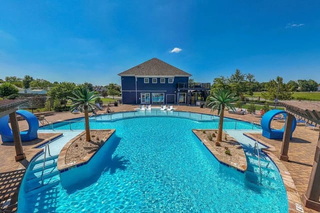 Pool with palm trees and blue lounge chairs exterior at Cobalt Row in Murfreesboro Student Accommodation
