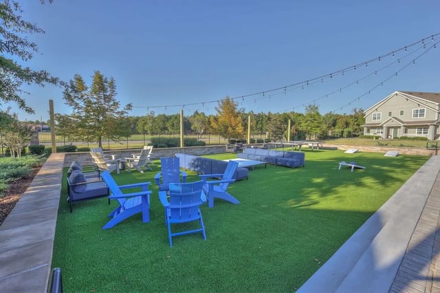 Outdoor seating lounge areas and cornhole game exterior at Cobalt Row in Murfreesboro Student Accommodation