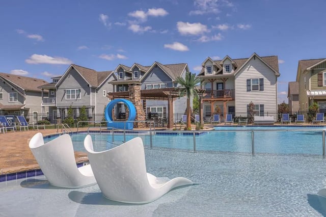 Pool with lounge chairs and houses exterior at Cobalt Row in Murfreesboro Student Accommodation