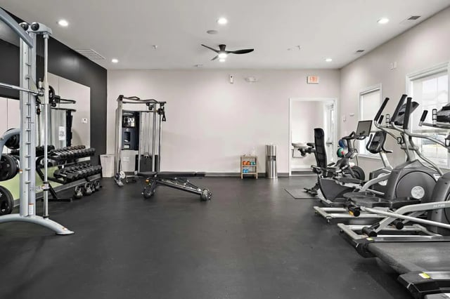 Weight machines dumbbells bench treadmill exercise room at The Gathering in Salisbury Student Accommodation