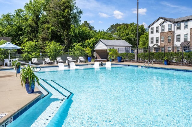 Swimming pool with lounge chairs building exterior at The Gathering in Salisbury Student Accommodation