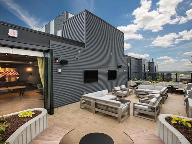 Outdoor seating area with pool table and grills patio at The James in Richmond Student Accommodation
