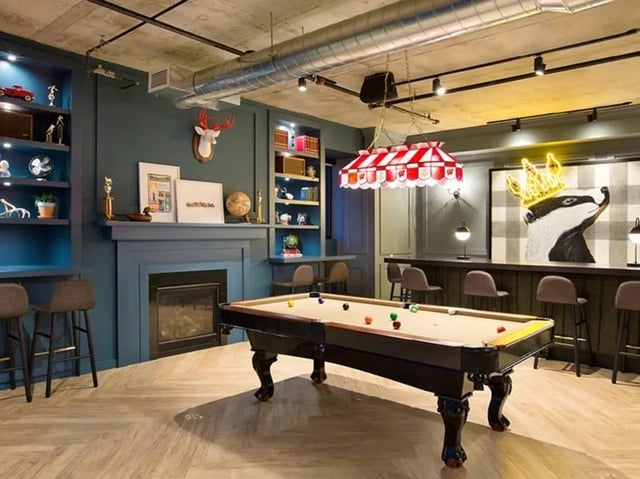 Pool table fireplace bar and shelving living room at The James in Richmond Student Accommodation