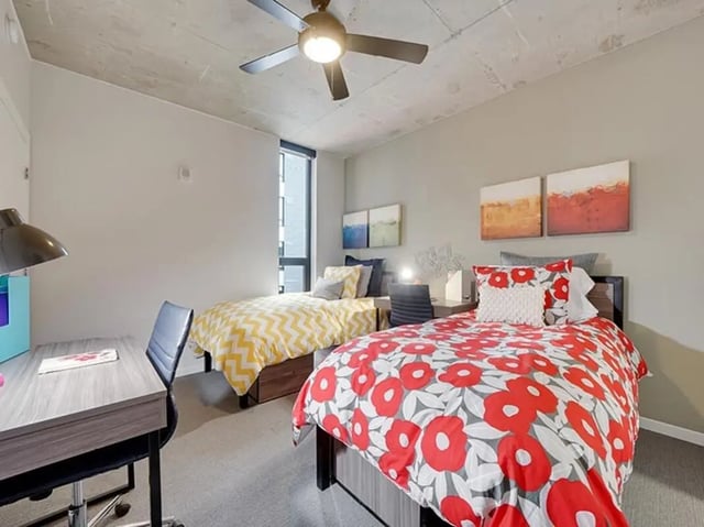 Two beds desks lamp ceiling fan bedroom at The James in Richmond Student Accommodation