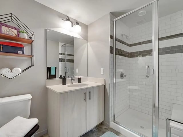 Toilet vanity mirror shower stall white tiles bathroom at The James in Richmond Student Accommodation