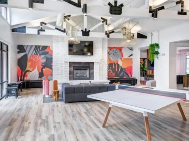 Ping pong table couch fireplace abstract art living area at East Edge in Tuscaloosa Student Accommodation