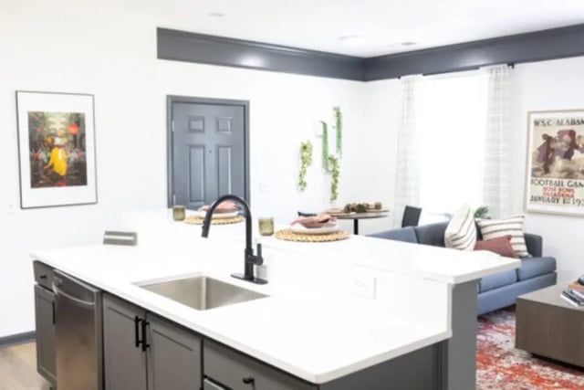 Kitchen island sink faucet and cabinets living room living room at East Edge in Tuscaloosa Student Accommodation