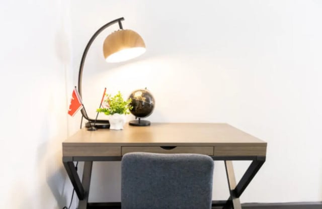 Desk with globe plant lamp and chair study area at East Edge in Tuscaloosa Student Accommodation