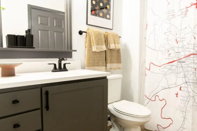 Vanity sink and toilet with map shower curtain Bathroom at East Edge in Tuscaloosa Student Accommodation